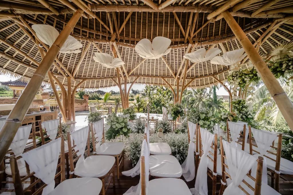 Pavilion seating dressed in white chiffon with rice field views